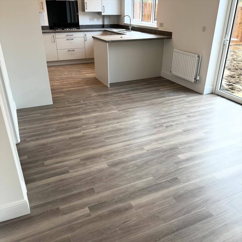 Wood-effect plank floor in an open-plan kitchen